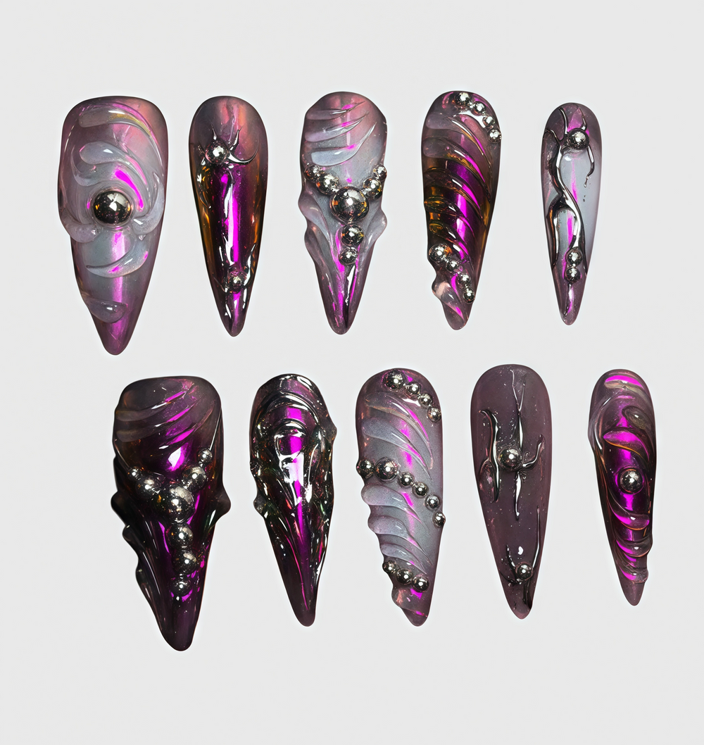 Stiletto-shaped cyberpunk press-on nails in chrome purple with metallic texture, 3D carved swirls and silver bead accents
