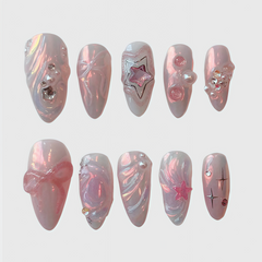 Almond shape pink press on nails with dreamy pearl shine, 3D stars, bows and crystal designs