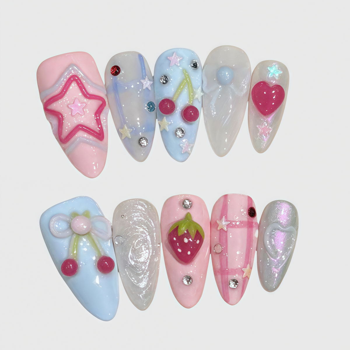 Almond shaped kawaii press-on nails featuring 3D pink stars, cherries, hearts, and strawberry elements with soft pastel colors.

