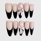 Almond-shaped press on nails in nude and black with 3D pink lily flower design