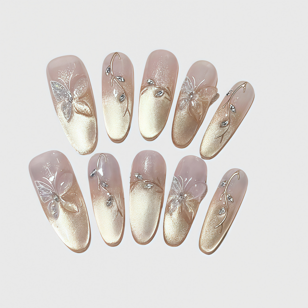 Almond-shaped press-on nails with gold gradient finish, 3D butterfly decorations, and crystal vines.