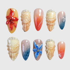 Set of oval-shaped press-on nails featuring shell textures, 3D floral designs, pearl accents, and tropical ombre gradients in sunset red, nude, and ocean blue