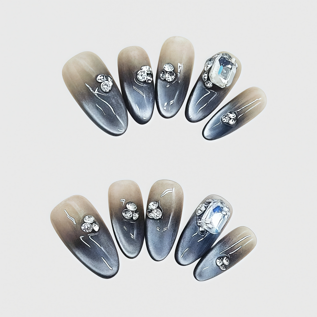 Almond-shaped black and brown gradient press-on nails with 3D rhinestones and a large crystal gem, featuring a bold and elegant ombré design.
